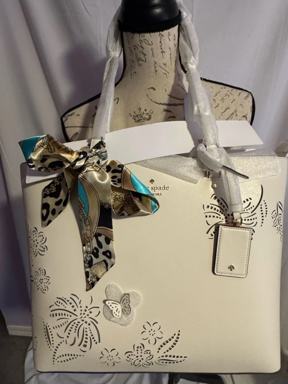 kate spade Cream Tote with Decorative Cutouts and Scarf Accent